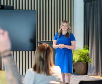 Wellbeing expert presents to a group of people.