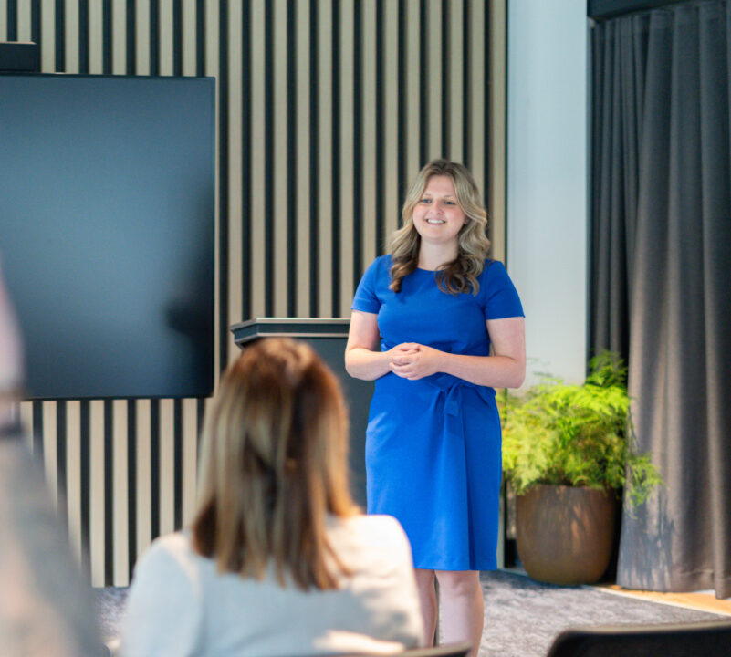 Wellbeing expert presents to a group of people.